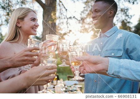 Happy young intercultural dates looking at one another with toothy smiles 66908131