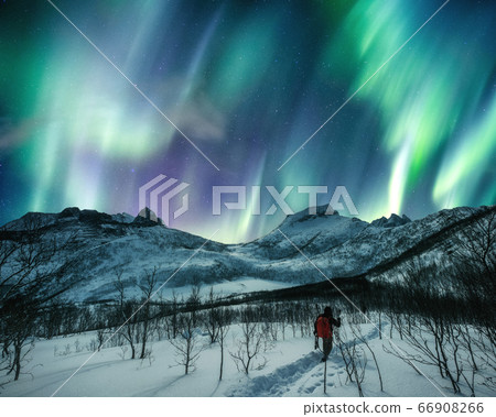 Man traveler mountaineering on snowy hill with 66908266