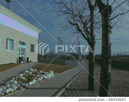 Sports center as seen from the public street with a vintage filter in Muggiano, Milan, Italy, 2019. Sports center as seen from the public street with a vintage filter in Muggiano, Milan, Italy, 2019. 66910641