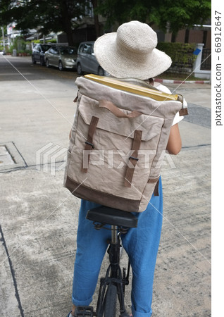 Woman riding black bicycle carrying boxes delivery Woman riding black bicycle carrying boxes delivery 66912647