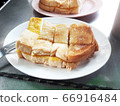 Slice of buttered toast topping with sugar and condensed milk  66916484