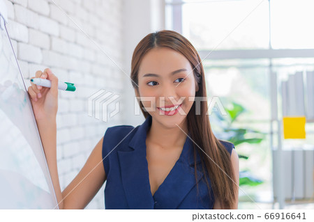 business woman working and writing on the glass board in office. Lifestyle female work concept. business woman working and writing on the glass board in office. Lifestyle female work concept. 66916641
