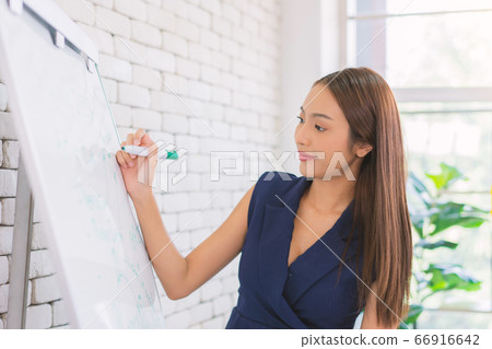 business woman working and writing on the glass board in office. Lifestyle female work concept. business woman working and writing on the glass board in office. Lifestyle female work concept. 66916642