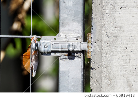 Silver door bolt on a wooden door . close up 66919418