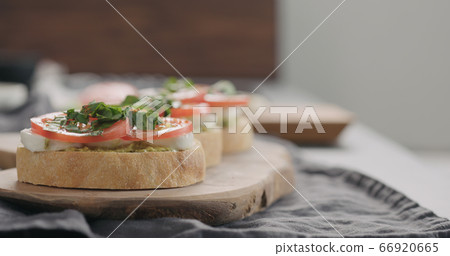 bruschetta with tomato, pesto and mozzarella on olive board bruschetta with tomato, pesto and mozzarella on olive board 66920665