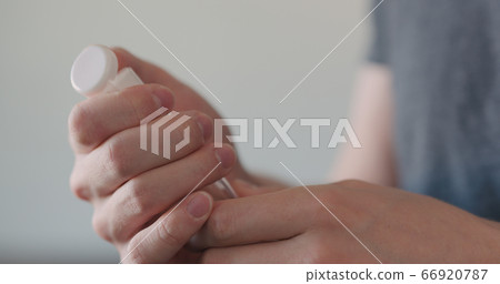 man apply sanitizer gel to his hands closeup man apply sanitizer gel to his hands closeup 66920787