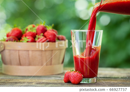 strawberry smoothie pouring in glass strawberry smoothie pouring in glass 66927737