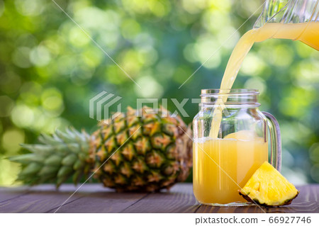 pineapple juice pouring in mason jar 66927746