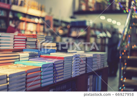 lot of new books in hardcover. image of Abstract Blur people at book store in shopping mall for background usage. toned lot of new books in hardcover. image of Abstract Blur people at book store in shopping mall for background usage. toned 66927958
