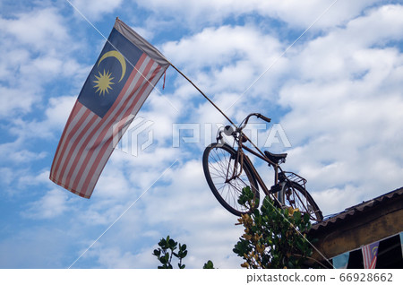 Malaysia flag hang on bicycle at rooftop Malaysia flag hang on bicycle at rooftop 66928662