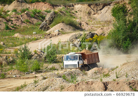 Dump truck transports sand and other minerals in the mining quarry Dump truck transports sand and other minerals in the mining quarry 66929678