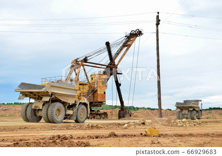 Big mining truck transport of minerals in the quarry. Big mining truck transport of minerals in the quarry. 66929683