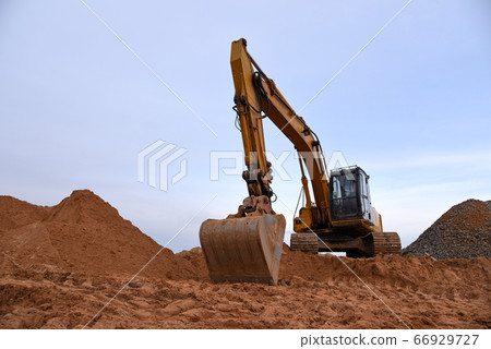 Track-type excavator during earthmoving works at open-pit mining Track-type excavator during earthmoving works at open-pit mining 66929727