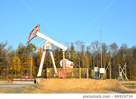 Oil drilling derricks at desert oilfield for fossil fuels output and crude oil production 66929734