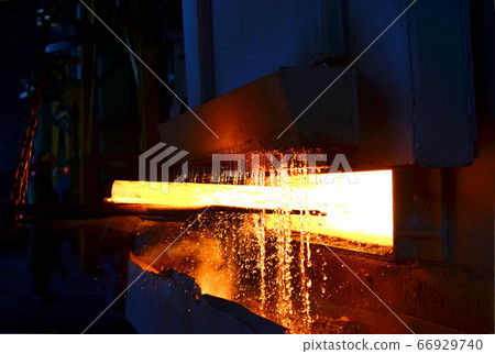Steel quenching at high temperature in industrial furnace at the workshop of a forge plant. 66929740