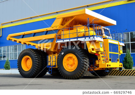 Giant mining dump truck, after being discharged from the conveyor, is tested at factory test site. Giant mining dump truck, after being discharged from the conveyor, is tested at factory test site. 66929746
