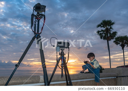 .The camera is capturing pictures of a cute boy .The camera is capturing pictures of a cute boy 66930110