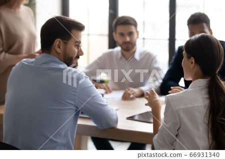 Rear view businesswoman speaking, discussing project at corporate meeting 66931340