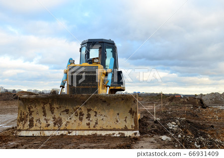 Bulldozer during of large construction jobs at building site. 66931409