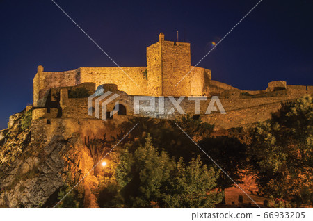 Walls and tower of Castle over rocky cliff at dusk in Marvao Walls and tower of Castle over rocky cliff at dusk in Marvao 66933205