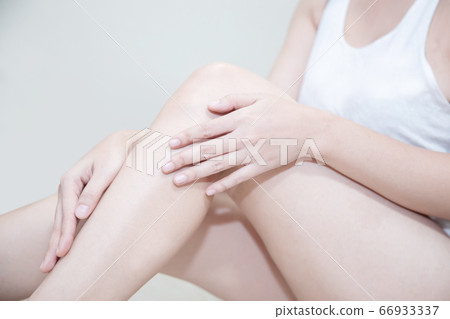 Asian Woman Applying Moisturizer Cream on Her Leg Asian Woman Applying Moisturizer Cream on Her Leg 66933337