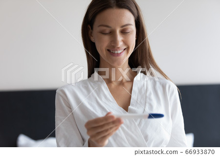 Happy woman feel excited with positive pregnancy test results Happy woman feel excited with positive pregnancy test results 66933870