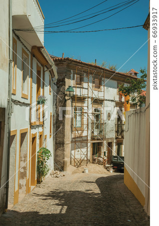 Old house with scaffolding for refurbishment at Castelo de Vide 66933917