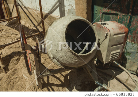 Old cement mixer and sand in a construction site at Castelo de Vide 66933925
