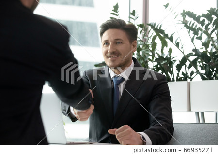 Two businessmen greeting with handshake. Business meeting, interview, agreement concept 66935271