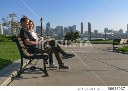Couple relaxing on San Diego City bench 66935987