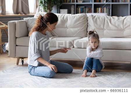 Strict mother scolding offended naughty little daughter, pointing finger Strict mother scolding offended naughty little daughter, pointing finger 66936111