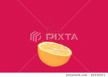 concept of an orange falling into water on a red, coral shiny background falls under water with bubbles 66936911