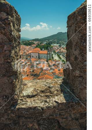 Cityscape with roofs and cathedral seen by crenel at Castelo de Vide Cityscape with roofs and cathedral seen by crenel at Castelo de Vide 66938611
