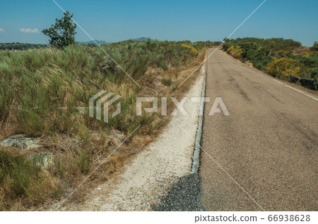 Road through wild landscape Road through wild landscape 66938628