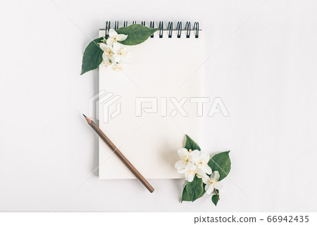 Notepad with pencil and flowers. Notepad with pencil and flowers. 66942435