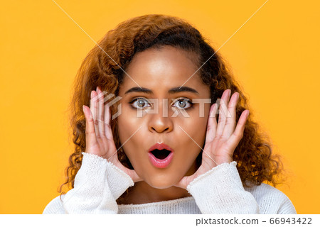 African American woman with hands cupped around face African American woman with hands cupped around face 66943422