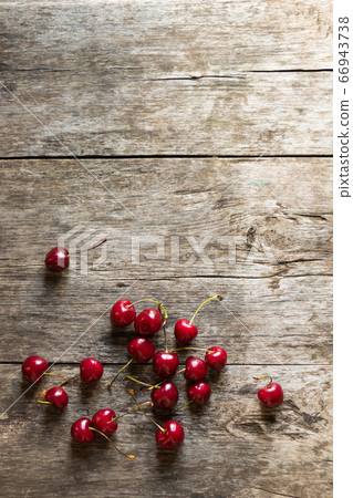 Ripe fresh sweet cherry lies on a wooden rustic table. Healthy sweet dessert Ripe fresh sweet cherry lies on a wooden rustic table. Healthy sweet dessert 66943738