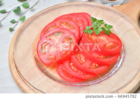 Tomato sliced salad is cold and easy in summer. Simple food. Serve with rock salt. Tomato sliced salad is cold and easy in summer. Simple food. Serve with rock salt. 66945782