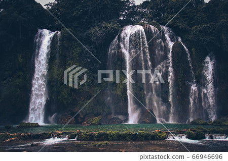 Dark and moody cinematic scenery of Ban Gioc or Detian Falls in Cao Bang, Vietnam during the winter season Dark and moody cinematic scenery of Ban Gioc or Detian Falls in Cao Bang, Vietnam during the winter season 66946696