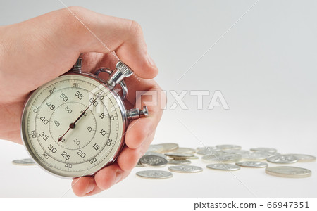 time is money. hand holding a stopwatch  66947351