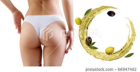 Female buttocks near olive oil circulation. Slimming concept. Female buttocks near olive oil circulation. Slimming concept. 66947482