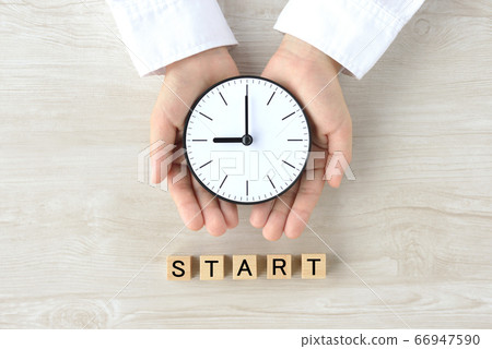 Child's hand holding a clock Child's hand holding a clock 66947590