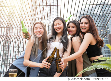 young asian woman happy  party drink beer. 66949156