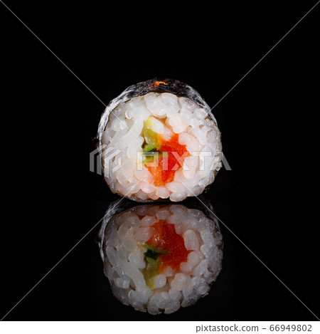 Maki sushi with cucumber and salmon on black background with its reflection. Sushi menu. Japanese food. Maki sushi with cucumber and salmon on black background with its reflection. Sushi menu. Japanese food. 66949802