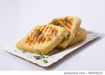 Fried potato pies. Patties with dill. Cheap recipe for homemade fried pies on a white background. Easy meal idea. Fried potato pies. Patties with dill. Cheap recipe for homemade fried pies on a white background. Easy meal idea. 66949829