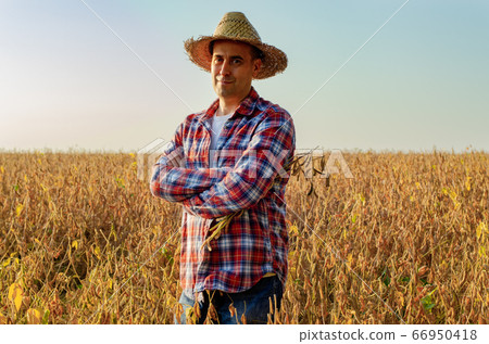 Caucasian middle age farmer in straw hat standing Caucasian middle age farmer in straw hat standing 66950418