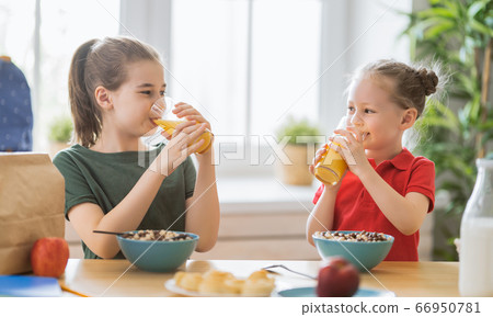 Happy children having breakfast. 66950781