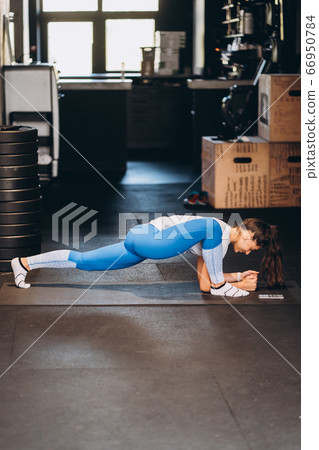 Portrait of attractive young woman doing yoga or pilates exercise Portrait of attractive young woman doing yoga or pilates exercise 66950784