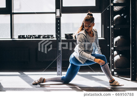 Portrait of attractive young woman doing yoga or pilates exercise Portrait of attractive young woman doing yoga or pilates exercise 66950788