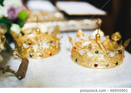 Golden crowns lying on the table in church Golden crowns lying on the table in church 66950901
